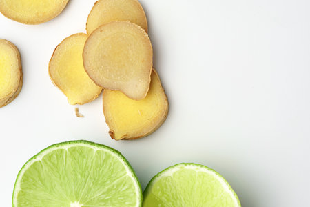Lime and ginger slices on white backgroundの写真素材