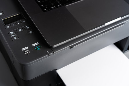 Printer and laptop on grey table in officeの写真素材