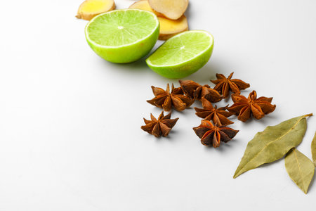 Slices ginger and lime with spice on white background