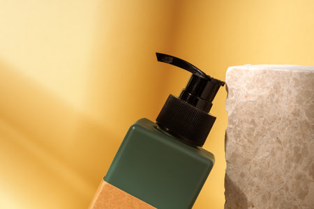 Cosmetic jar and stone on brown backgroundの写真素材