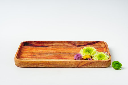 Wooden tray with flowers isolated on white backgroundの写真素材
