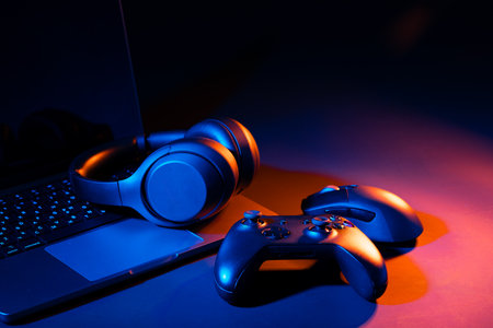 Computer keyboard, mouse and joystick on black background