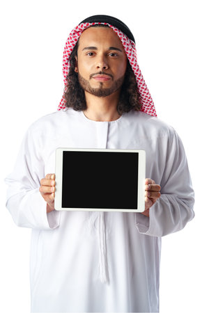 Young Arab man in traditional dress thobe showing digital tablet with black screen on white backgroundの写真素材