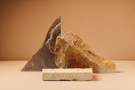 Piece of granite stone against beige background with shadowsの写真素材