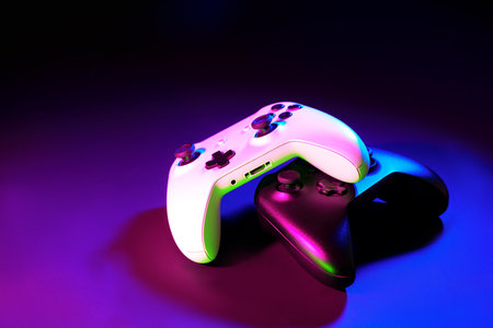 Gaming joystick on black background in neon lightの写真素材