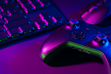 Computer keyboard, mouse and joystick on black backgroundの写真素材