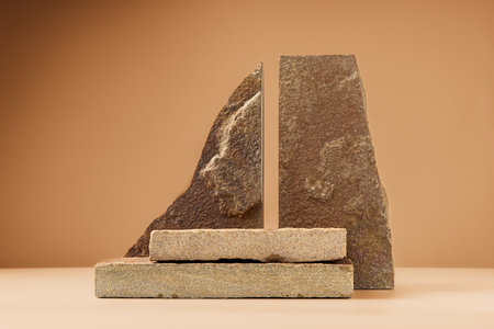 Piece of granite stone against beige background with shadowsの写真素材