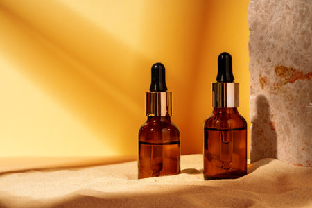 Essential oil glass bottle on beige background.の写真素材