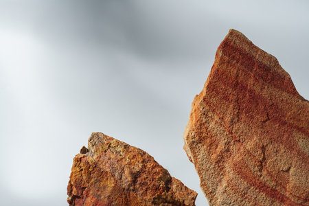 Piece of granite stone on white background with shadowsの写真素材