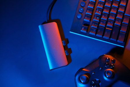 Gaming concept on black background with computer keyboard and joystick