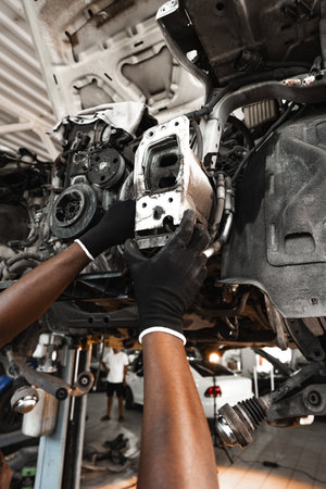 Close up of hands of auto mechanic working in a garage
