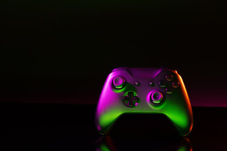 Gaming joystick on black background in neon light