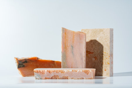 Piece of granite stone on white background with shadowsの写真素材