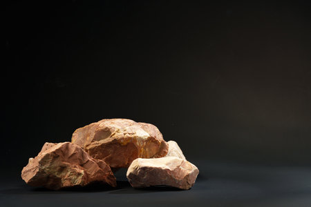 Pieces of granite stone on black background studio shot