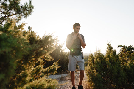 Portrait of hiker man with backpack trekking in the mountains