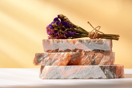 Pieces of granite stones against beige background with shadowsの写真素材
