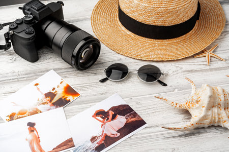 Photo camera with colorful printer photos on gray deskの写真素材