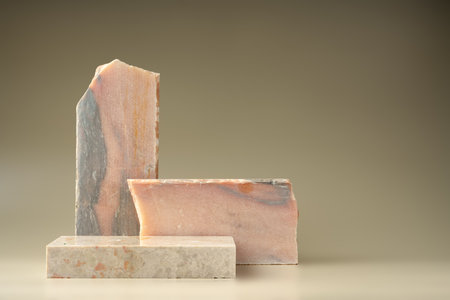Pieces of granite stone on beige background for displayの写真素材