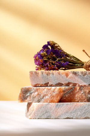 Pieces of granite stones against beige background with shadowsの写真素材