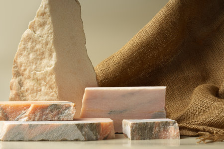 Granite stone podium decorated with sackcloth on beige backgroundの写真素材