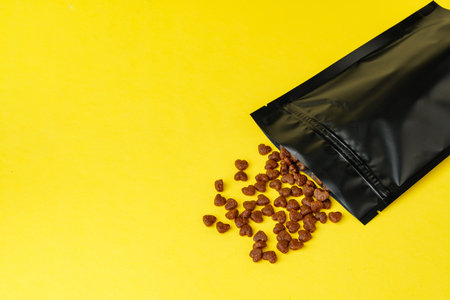 Cat food on yellow background studio shotの写真素材