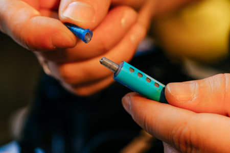 Male hands holding syringe with thermal paste close upの写真素材