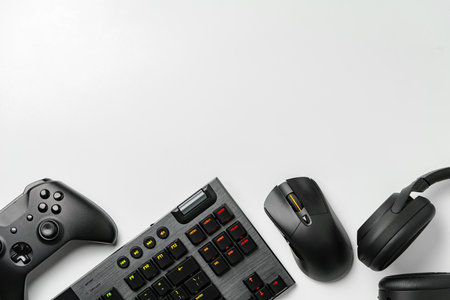 Top view of gamer table with computer keyboard, joystick and headphones