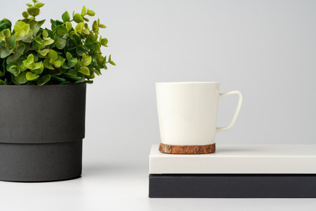 Coffee mug on white office table mock upの写真素材
