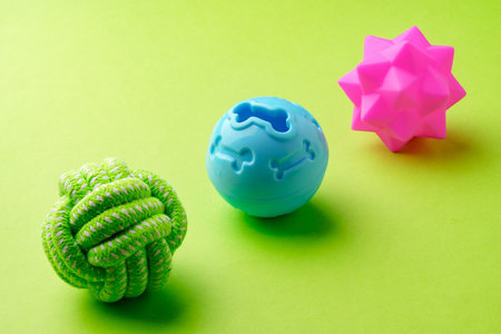 Colorful pet toys balls on green backgroundの写真素材