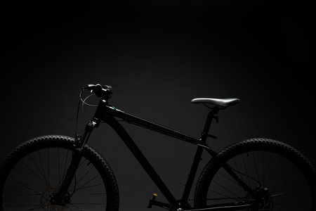 Black mountain bicycle on black backgroundの写真素材