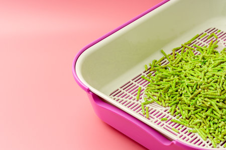 Pet litter box with bio filler on pink backgroundの写真素材
