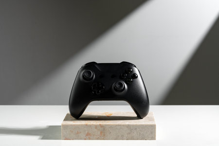 Joystick on sunlight against gray background close up