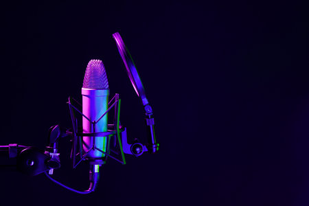 Professional microphone against black background in studioの写真素材