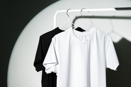 Blank T-shirt hanging in a spotlight in studioの写真素材
