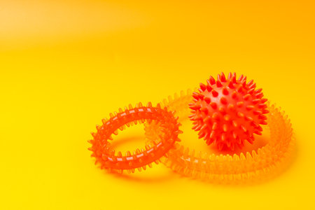 Pet toys on yellow background studio shotの写真素材