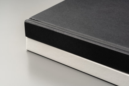 Blank notepad on gray background studio shot
