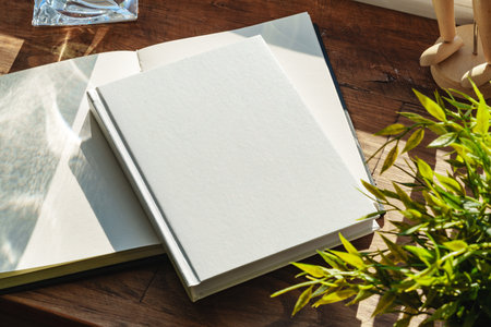 Books by the window on wooden windowsill in sunlightの写真素材
