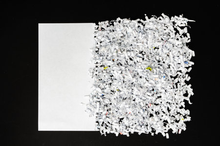Shredded white paper on black background close upの写真素材