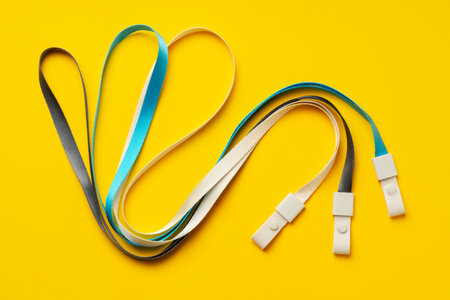 Badge strings on yellow background close upの写真素材
