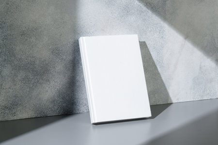 White notepad with hard cover on gray backgroundの写真素材