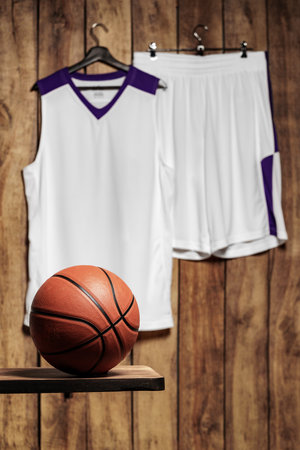 Basketball player outfit hanging on wooden backgroundの写真素材