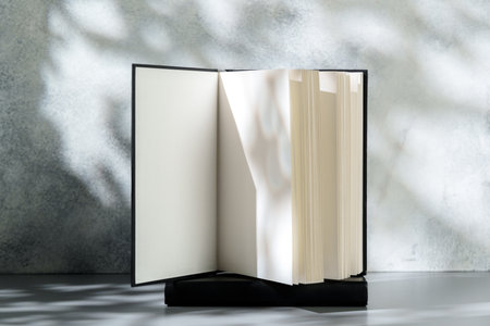 Blank open notepad on gray background studio shotの写真素材