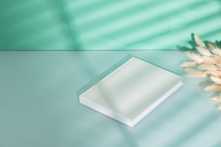 Blank picture frame and dried flower in a vase on mint backgroundの写真素材