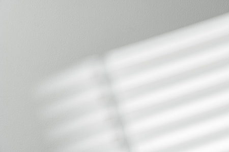 Gray background with shadows and light from window