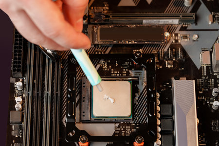 Man applies thermal paste to the CPUの写真素材