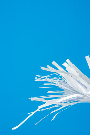 Shredded paper pieces on a blue backgroundの写真素材