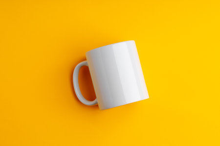 Ceramic mug on yellow studio background close upの写真素材