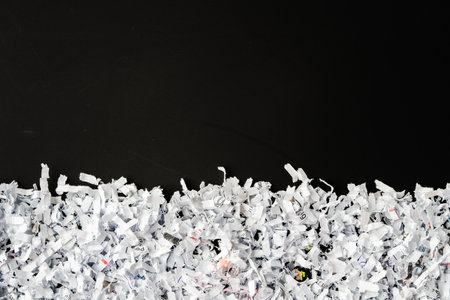 Shredded white paper on black background close upの写真素材