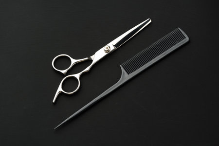 Hairdressing scissors on black background studio shot