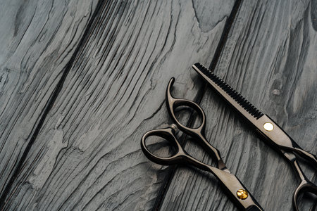 Hairdressing scissors on black wooden background close upの写真素材